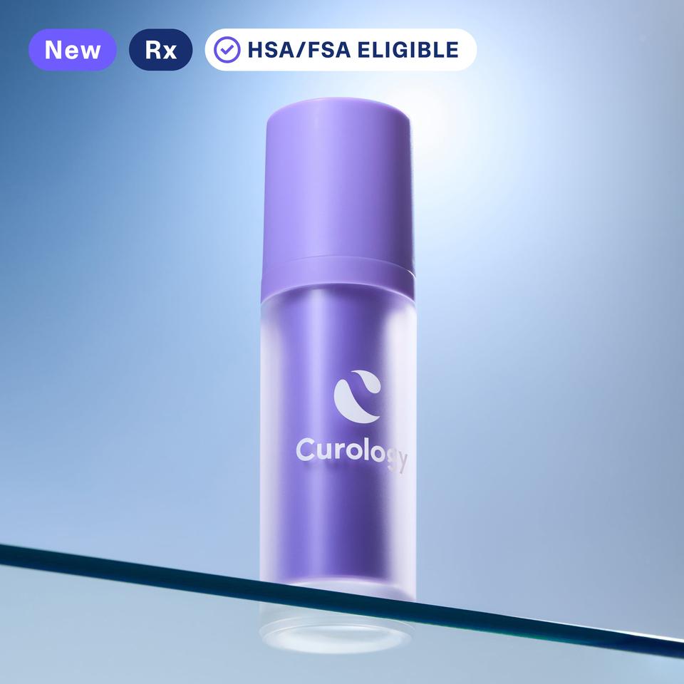 A purple cylindrical bottle of Curology DayPrime Rx sits atop a glass shelf against a blue background with sunlight shining.